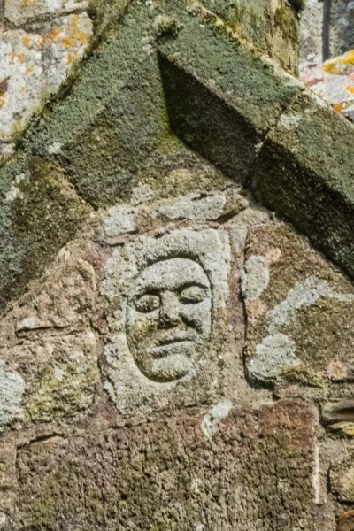 The peculiar carved face over the porch entrance