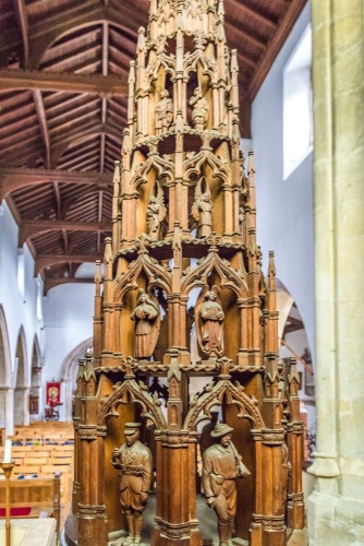 The beautifully-carved 19th-century font cover