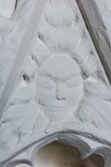 Carved head over the chapel piscina