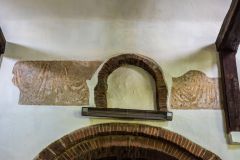 Norman brick window arches and post-Reformation wall paintings