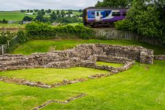 A train rushes past Poltross Burn Milecastle