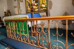 The ornate wrought-iron communion rails