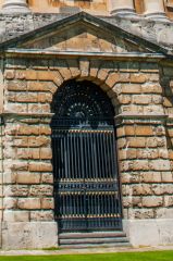 A ground level rusticated portico