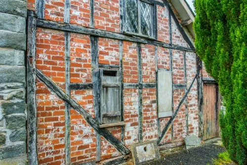 A 17th-century timber-framed cottage beside the churchyard