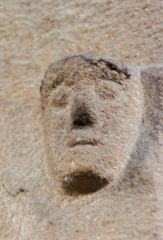 A worn medieval corbel head