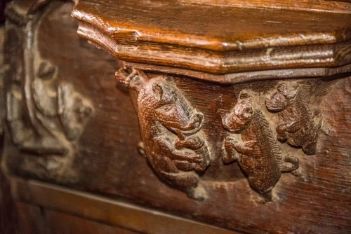 16th-century misericord of a pig playing bagpipes