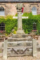 The village stocks, war memorial, and pub