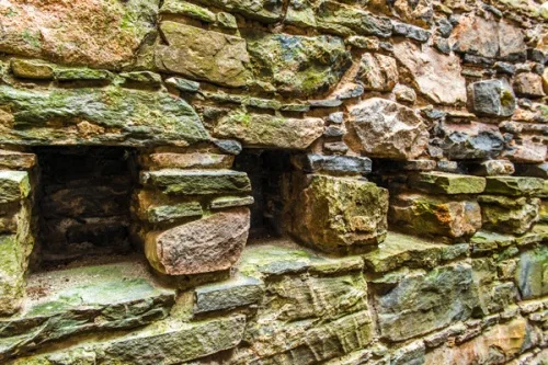 Holes for floor joists in the barrack wall