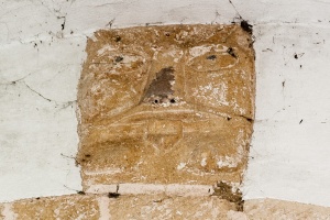 Grotesque face, south doorway