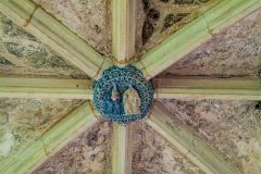 Painted roof boss in the vaulted entrance