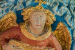 A painted angel roof boss