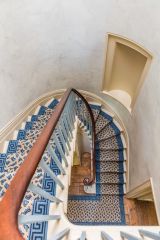 The spiral stairs down to the kitchen