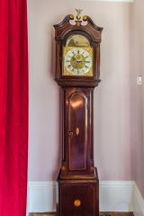 A longcase clock in the dining room