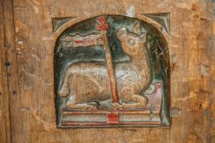 Carved bench end of an Agnus Dei symbol