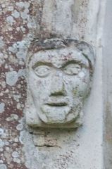 Medieval carved head, church exterior