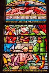 Biblical scene in a richly coloured stained glass window
