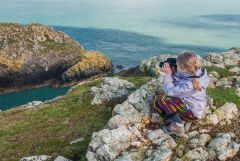 An avid birdwatcher with binoculars