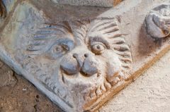 A lion's head on the font base
