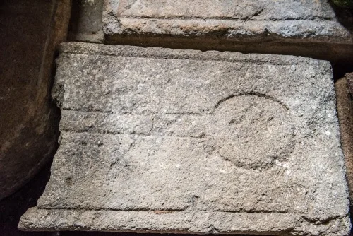 13th-century grave slab under the tower