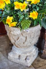 Medieval font bowl used as a flower pot