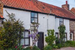 A pretty cottage on the greeen