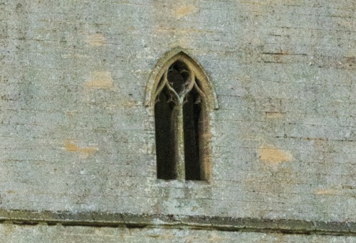 The upper floor still has its window mullions and tracery