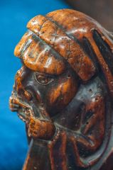 15th century bench end of a man with a toothache