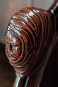 Carved bench end of a woman's head