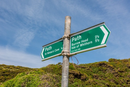 Where the glen meets the shore is a signpost
