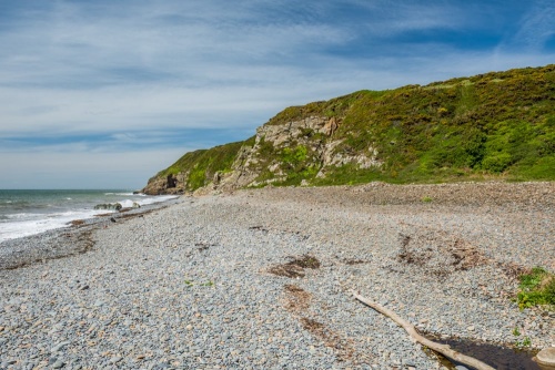 The cave is visible along the shore