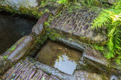 The stone-lined holy well basin