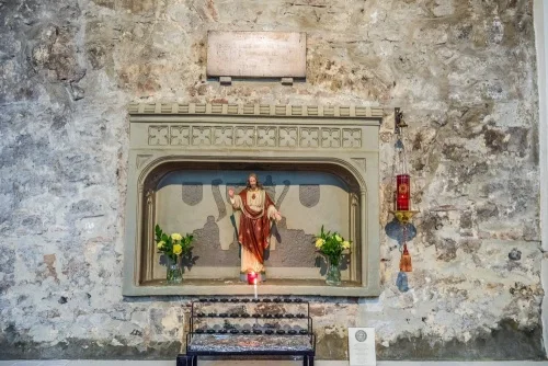 Easter Sepulchre set in a 12th-century wall
