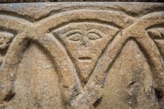 Carved face on the Norman font