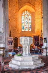 The 15th century font and tower arch