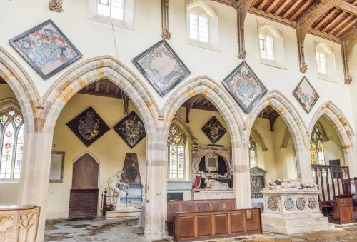 Cave family hatchments line the nave arcade