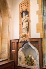 An ornate 15th century statue niche and 13th century piscina