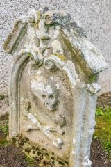 Skull and crossed bones on a gravestone
