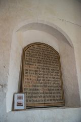 The old dedication board in a blocked Norman window
