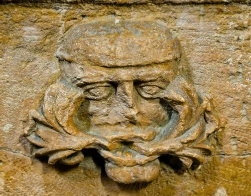 Green Man carving on the font