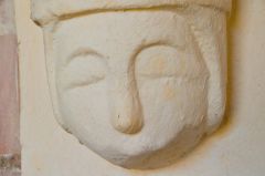 A sleepy looking corbel head