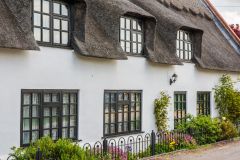 A thatched cottage opposite the church