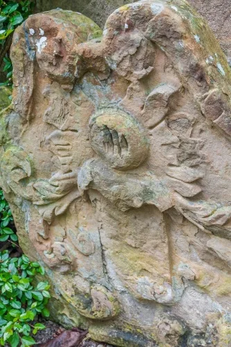 Worn 18th-century gravestone in the churchyard