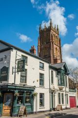 The west tower peering over the Ring of Bells pub