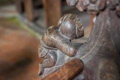 Bench end of a man climbing