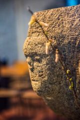 Another carving of a face on the Norman font