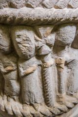 Carved figure carrying a cross