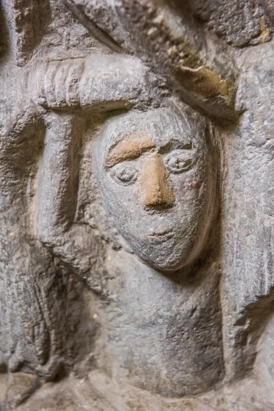 Detail of a carved figure on the font