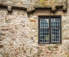 A mullioned window and exterior corbeling