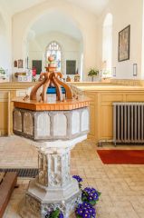 The late Norman font bowl atop its 14th century stem