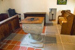 The plainly carved Norman font